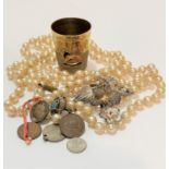 A string of paste pearls, a British Empire Exhibition thimble, a full enameled measure with line