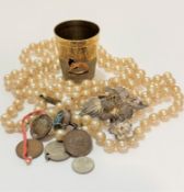 A string of paste pearls, a British Empire Exhibition thimble, a full enameled measure with line