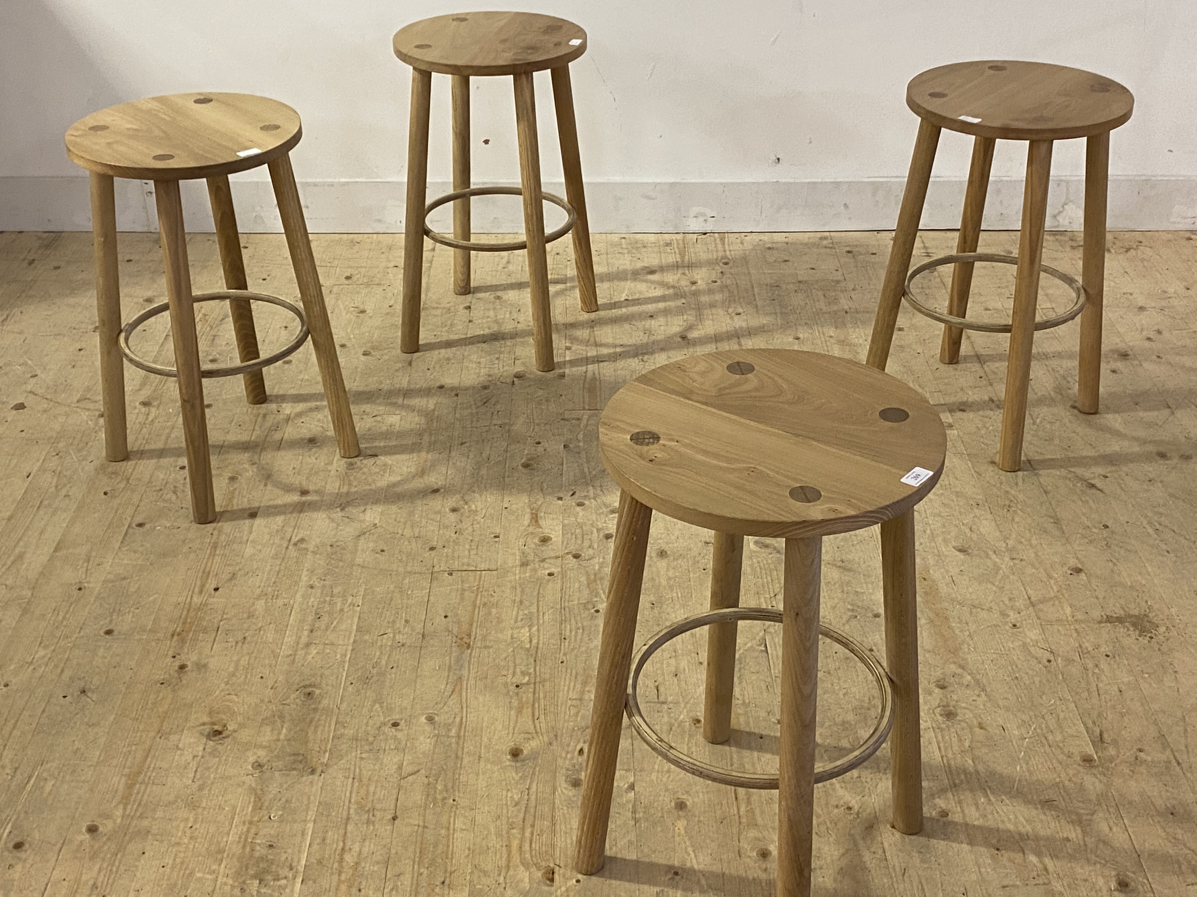 A set of four contemporary ash stools, the circular seats raised on turned supports united by a - Image 2 of 2