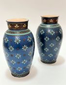 A pair of Mettlach art pottery baluster vases, the tops with lotus flower incised and enamelled