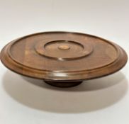 An Edwardian walnut table top circular Lazy Susan with moulded edge, raised on turned column and