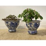 A large matched pairs of Chinese blue and white ceramic vases of squat flared form, naively