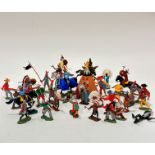 A collection of Britain's plastic cowboys, Native American figures, knights, totem pole, teepee,