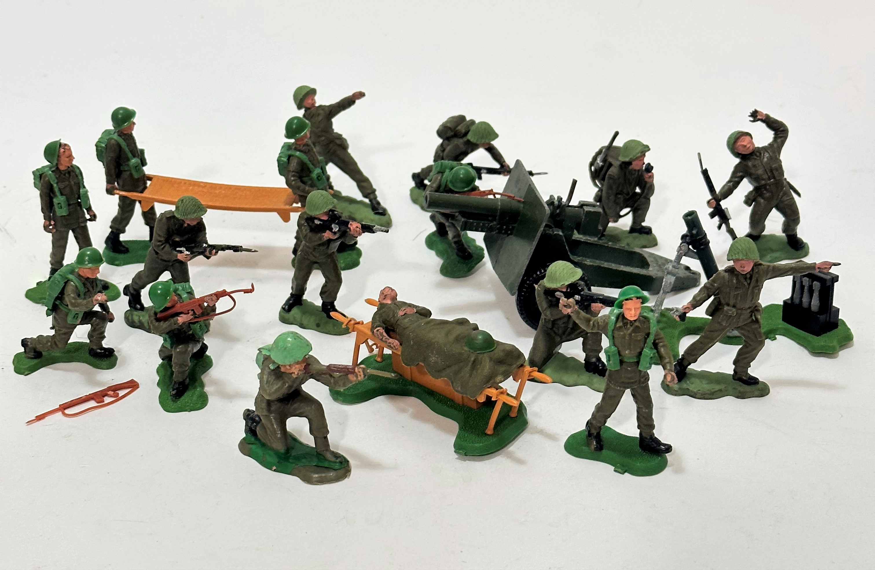 A set of Britain's plastic WWII infantry men complete with gun, stretcher, figures, radio operator