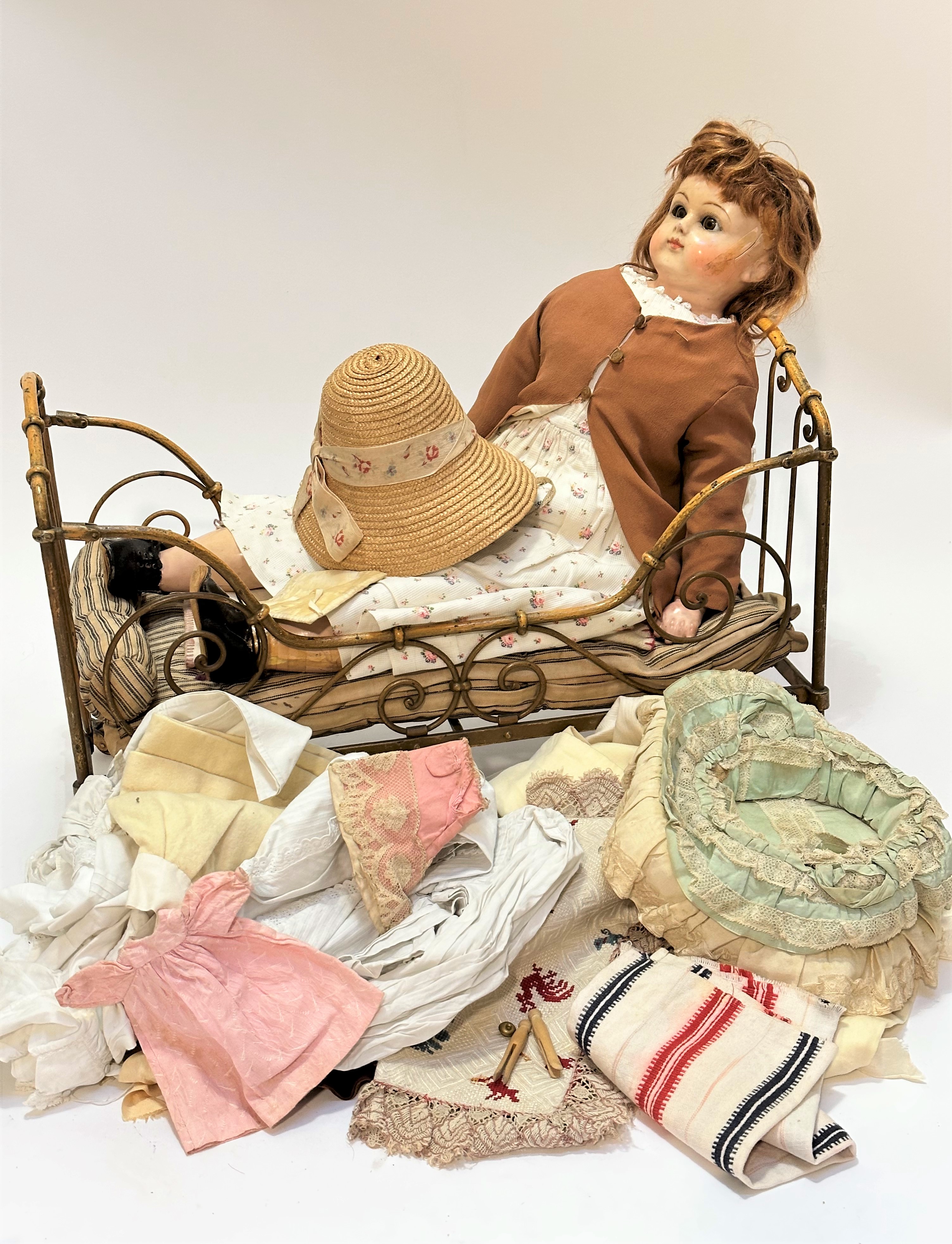 A composition late 19thc early 20thc doll in the Victorian style with stuffed joined body and