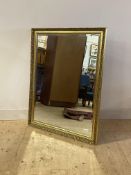 A floral gilt composition framed wall mirror with bevelled plate 87cm x 112cm