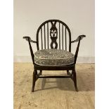 Ercol, a stained elm and beech lounge chair, with hoop, spindle and splat back over upholstered seat