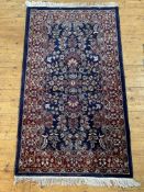 A Persian Tabriz rug, hand knotted, the blue field and guarded border profusely decorated with