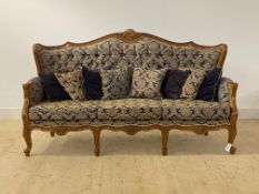 An upholstered and carved walnut three seat sofa in the baroque taste (H109cm, W190cm, D67cm)