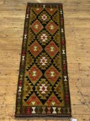 A Chobi kilim runner fur of typical geometric design, 200cm x 65cm