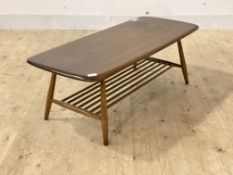 Ercol, a stained elm coffee table with magazine rack and turned supports, H37cm, W105cm, D48cm