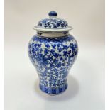 A modern blue and white baluster vase decorated with chrysanthemum and leaf design with lotus border