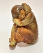 A Lladro Spanish pottery Eskimo boy seated figure decorated with brown glaze, signed verso, (17cm