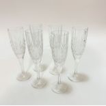 A set of six crystal moulded champagne flutes on faceted stems and circular moulded bases, (12cm x
