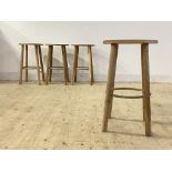 A set of six contemporary ash stools, the circular seats raised on turned supports united by a