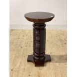 A stained mahogany pedestal plant stand, the circular top raised on a spiral turned column H71cm