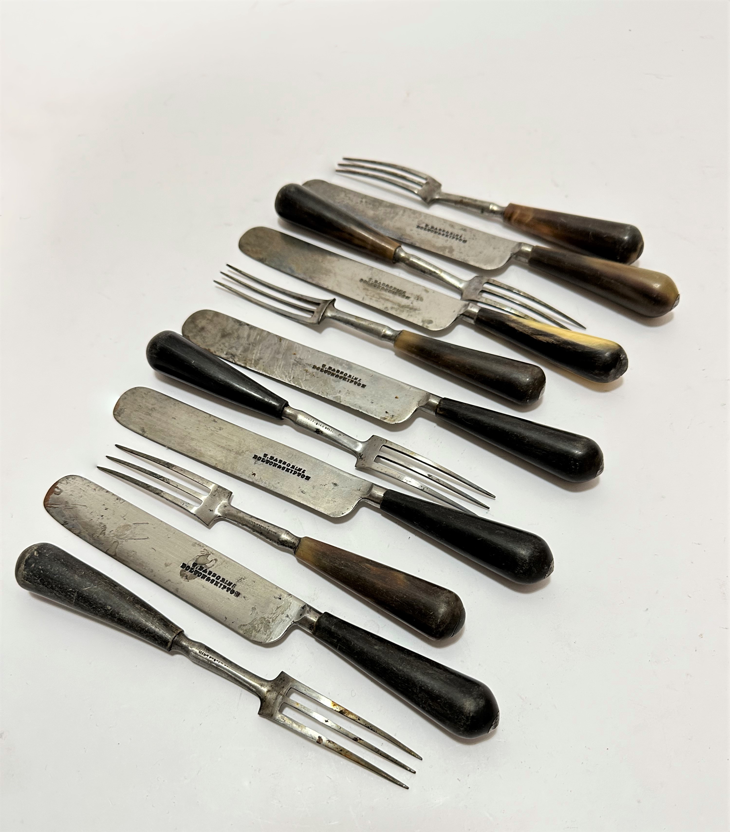 A set of six 19thc horn handled hand forged steel three pronged forks and a set of five knives