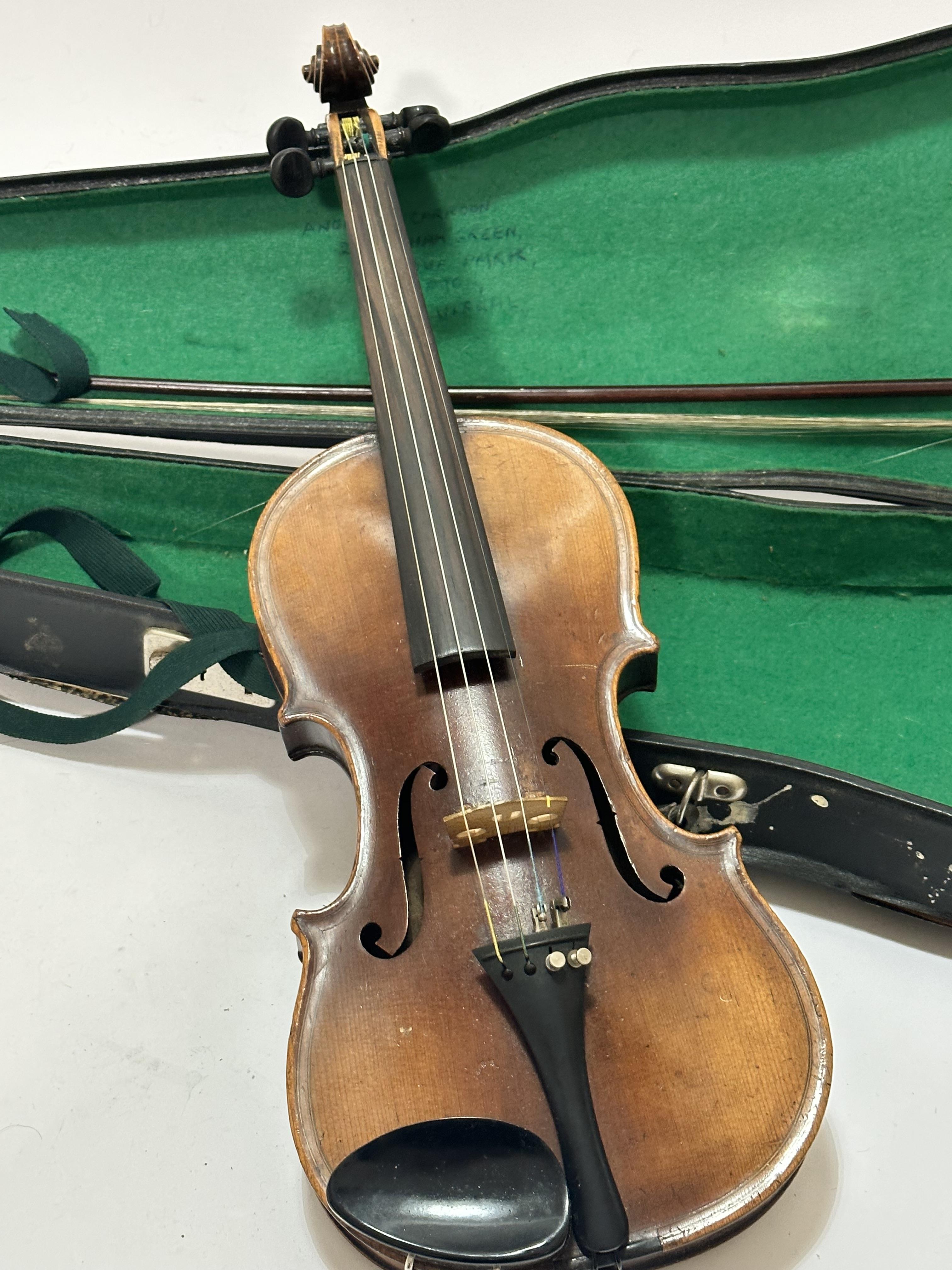 An Italian Magini two piece violin with paper label D E U T I C H E U R B E I T, spilt at back and