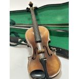 An Italian Magini two piece violin with paper label D E U T I C H E U R B E I T, spilt at back and