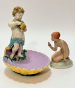 A Minton style pottery figure of a cherub holding a watering can, handle missing, head repairs,