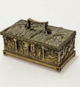 An Edwardian reproduction cast brass medieval style casket with relief cast panel depicting saints