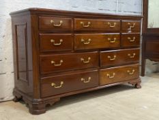 An 18th century inspired hardwood chest, fitted with an arrangement of ten drawers, canted sides,