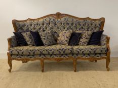 An upholstered and carved walnut three seat sofa in the baroque taste (H109cm, W190cm, D67cm)