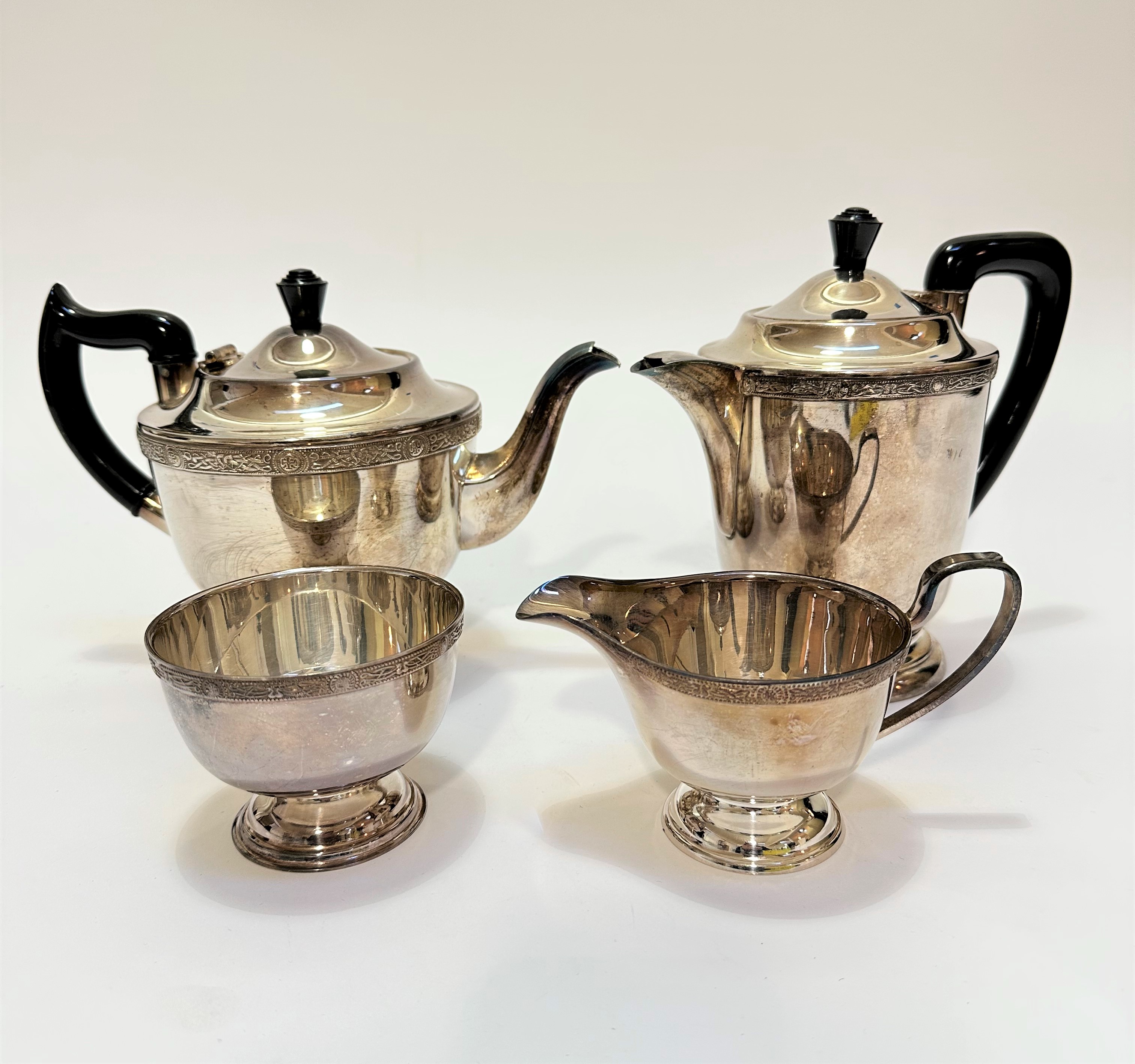 A four piece Epns tea and coffee service with Celtic style knot border and black bakelite knots