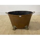 A 19th century brass and copper log bin of riveted construction, twin handled and standing on