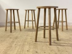 A set of four contemporary ash stools, the circular seats raised on turned supports united by a