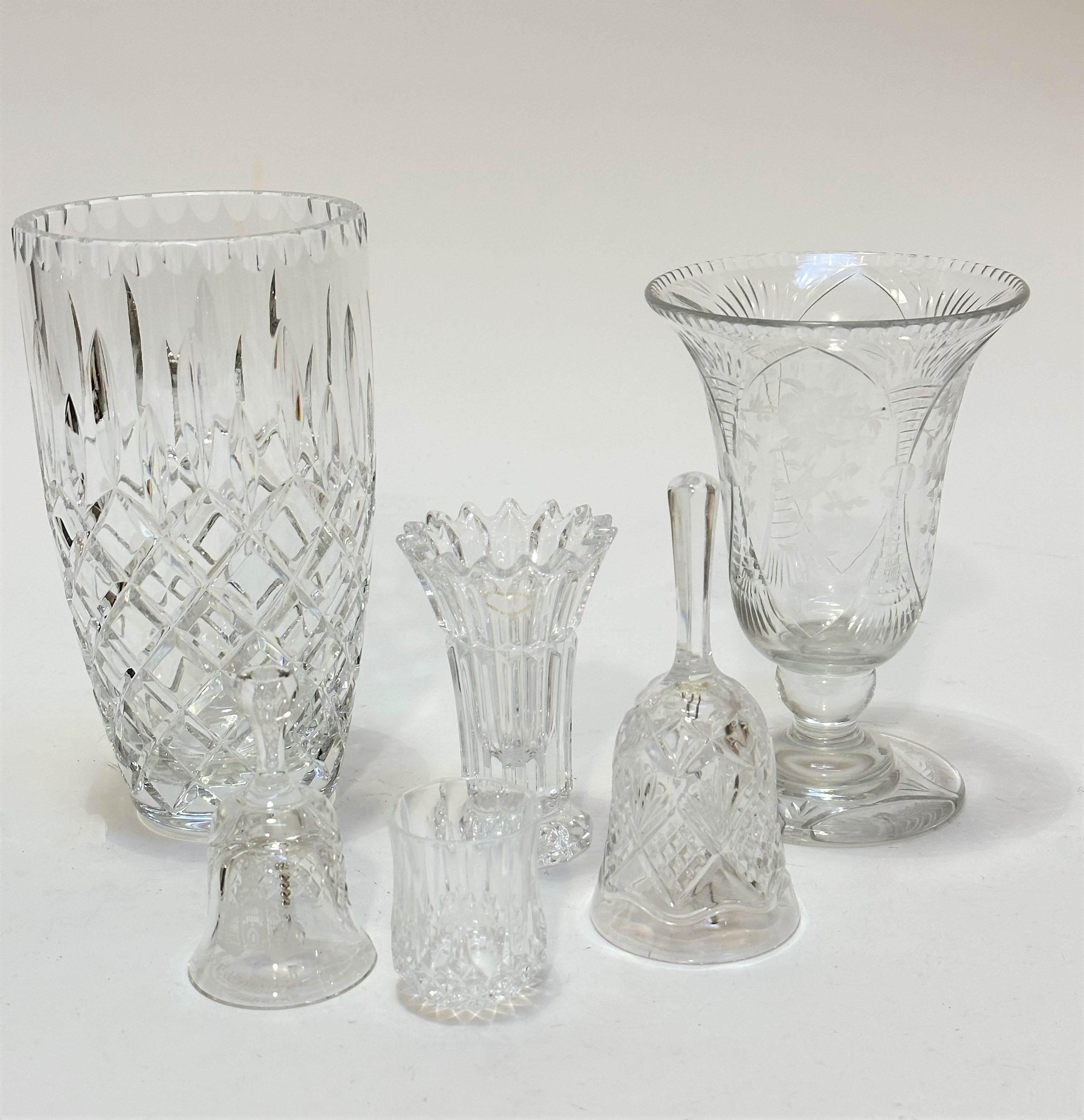 A crystal bell shaped vase with engraved floral sprays, raised on knop stem and circular base with