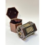 An Edwardian Lachenal & Co Manufacturers London patented concertina, the mahogany case, with leather