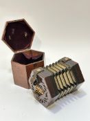 An Edwardian Lachenal & Co Manufacturers London patented concertina, the mahogany case, with leather