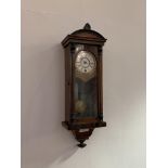 An early 20th century walnut cased regulator wall clock, white dial with Roman chapter ring,