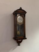 An early 20th century walnut cased regulator wall clock, white dial with Roman chapter ring,