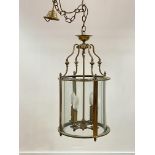 A lacquered brass hall lantern of cylindrical form, with chain and ceiling rose, H70cm (Excluding