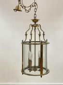 A lacquered brass hall lantern of cylindrical form, with chain and ceiling rose, H70cm (Excluding