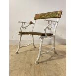 A Cast iron garden seat, white painted ends of naturalistic form (A/F) H86cm, W66cm, D50cm