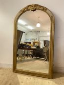 A Large Victorian wall mirror, the arched over painted gilt frame with shell and scrolling