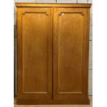 A Victorian bleached satinwood double wardrobe, one door with hanging rail behind, the other with