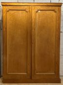 A Victorian bleached satinwood double wardrobe, one door with hanging rail behind, the other with