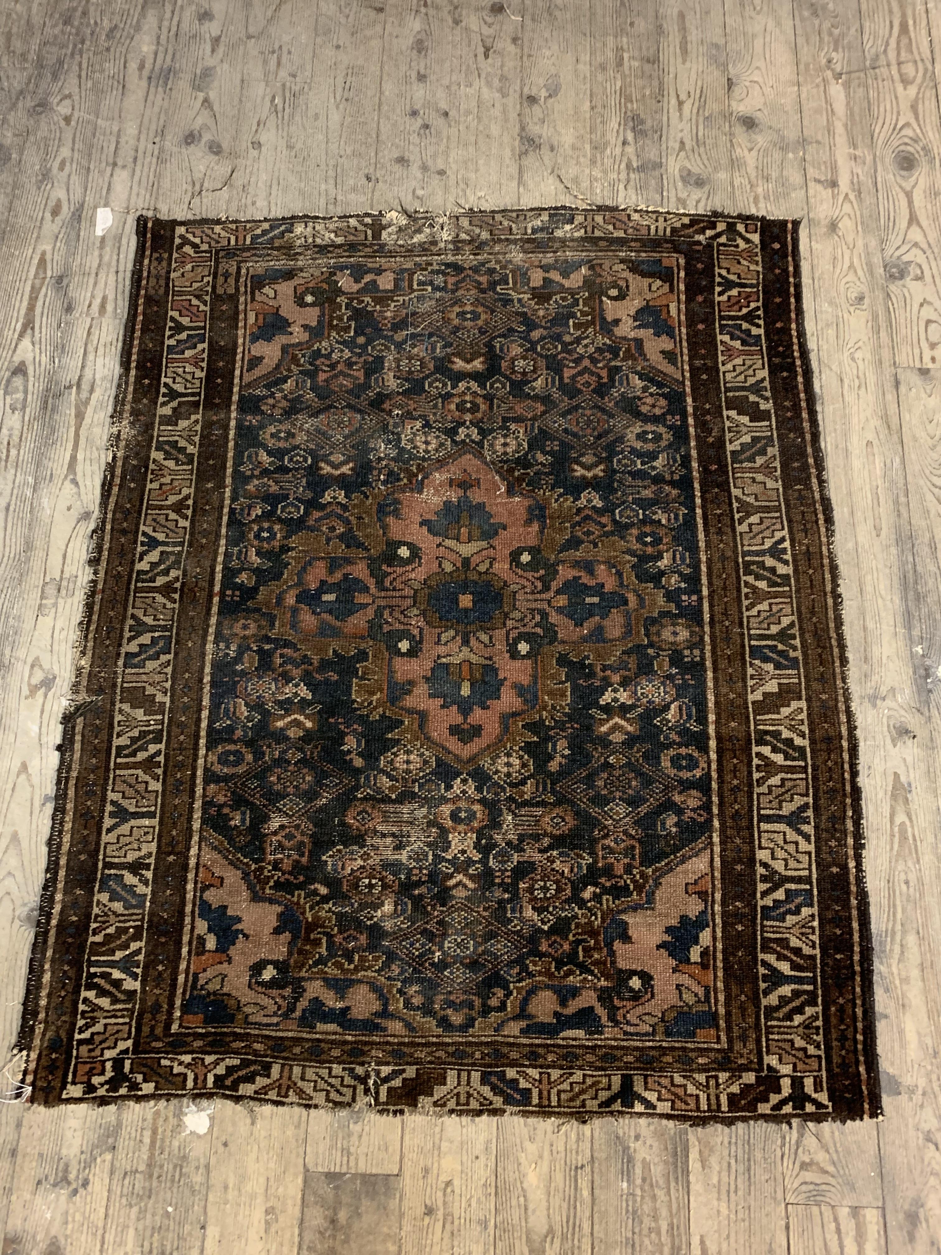 An Antique Persian hand knotted rug, the blue field with medallion and spandrels (Cut down) 105cm