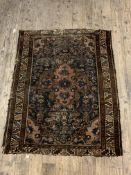 An Antique Persian hand knotted rug, the blue field with medallion and spandrels (Cut down) 105cm