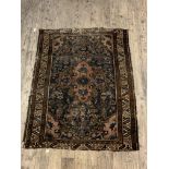 An Antique Persian hand knotted rug, the blue field with medallion and spandrels (Cut down) 105cm