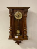 A late Victorian walnut cased Vienna style wall clock, twin train movement striking on a coiled