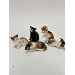 A group of five Royal Doulton china miniature cat figures, including two sleeping tabby cats, two