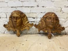 A pair of cast iron garden wall mounted water fountains formed as masks, W48cm