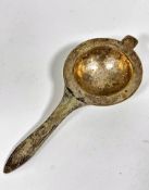 A Chinese white metal pierced tea strainer with hammered border and stylised dragon design to