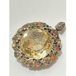 A late 19thc early 20thc brooch converted to pendant with faceted glass centre panel enclosed within