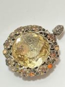 A late 19thc early 20thc brooch converted to pendant with faceted glass centre panel enclosed within